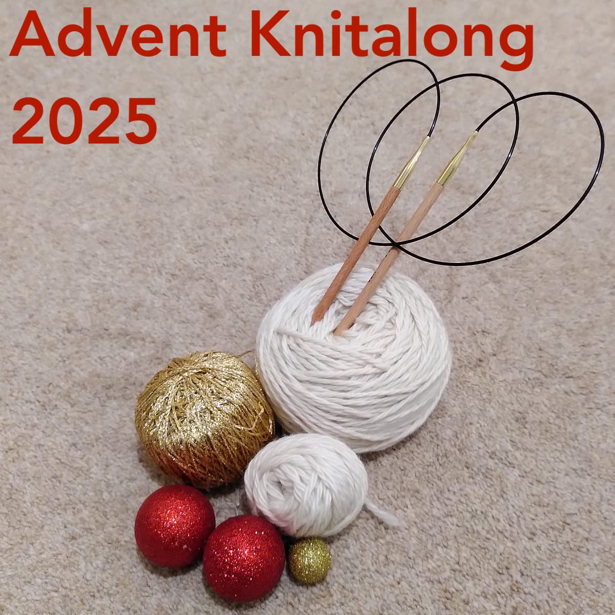 Balls of cream and gold wool with red and gold baubles and some knitting needles